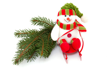 colorful snowman on sledges and twig of pine