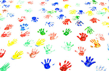 Multicolored handprints on the white wall