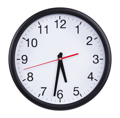 Office round clock shows half past five