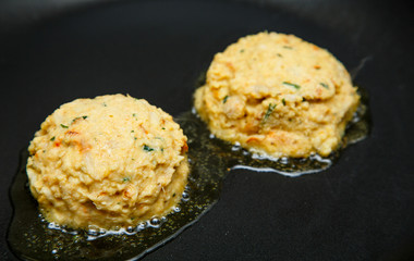 Raw Crab Cakes Placed in Hot Oil