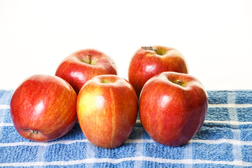 Fototapeta na wymiar Five Red Apples on Blue Towel