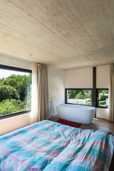 Modern villa, interior, bedroom with bathtub