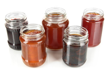 Tasty jam in banks isolated on white