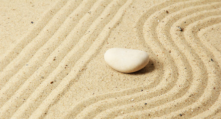 Obraz premium Zen garden with raked sand and round stones close up