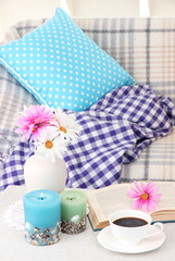 Home interior background with sofa, plaid, flowers and cup