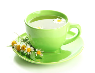 Cup of herbal tea with wild camomiles and mint, isolated
