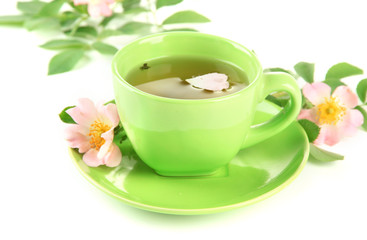 Cup of herbal tea with hip rose flowers, isolated on white