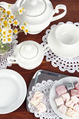 Table setting with chamomiles on wooden table