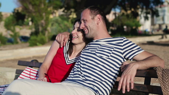 Couple in love relaxing on bench in park