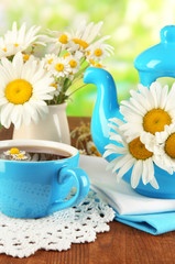 Beautiful bouquet chamomiles in teapot