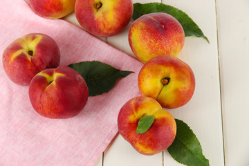 Peaches on napkin on wooden table