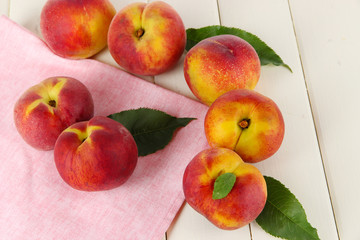 Peaches on napkin on wooden table