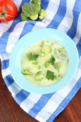 Cabbage soup in plates on napkin on wooden table