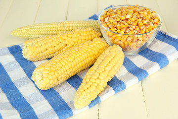 Fresh and dried corn on wooden background