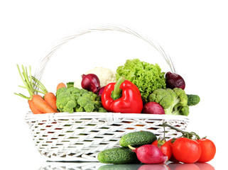 Fresh vegetables in white wicker basket on grey background