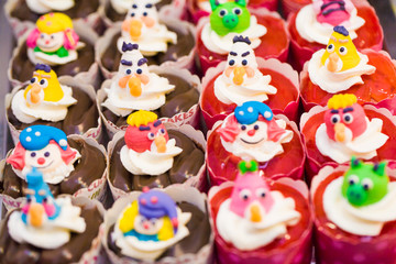 cupcakes with heart shape decoration and cartoon
