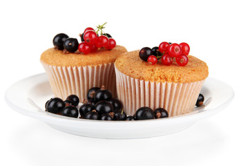 Tasty muffins with berries isolated on white