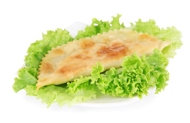 Tasty cheburek with fresh herbs on plate, close-up