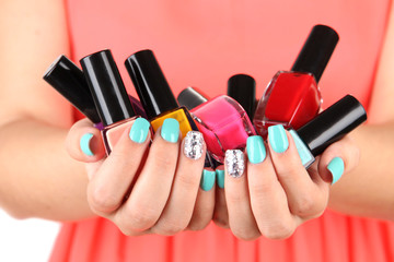 Woman hands with nail polishes, close-up
