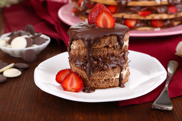 Chocolate cake with strawberry on wooden table close-up