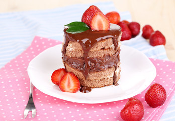 Chocolate cake with strawberry on table close-up