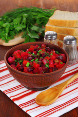 Beet salad in bowl on table close-up