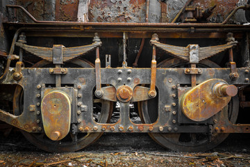 Grunge old steam locomotive wheels close up