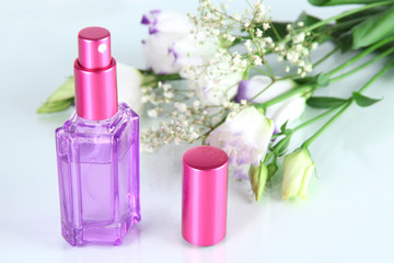 Fototapeta na wymiar Perfume in bottle and flowers isolated on white