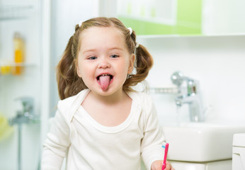 kid girl brushing teeth in bathroom © Oksana Kuzmina