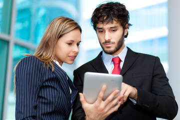 Two young businesspeople at work