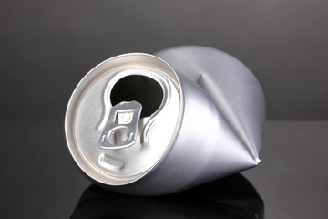 crumpled empty can on grey background