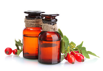 medicine bottles with hip roses, isolated on white