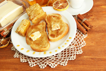 White bread toast with honey on wooden table