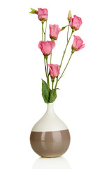Bouquet of eustoma flowers in vase isolated on white
