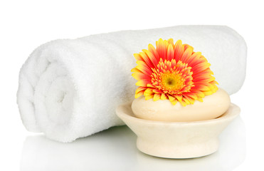 Obraz na płótnie Canvas Rolled white towel, soap bar and beautiful flower isolated