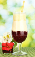 Delicious fruit smoothie on bright background