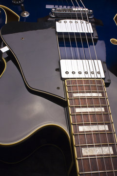 Close up of a Blue Hollow Body Electric 6-String Guitar
