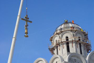 Fototapeta na wymiar Installing a cross on the dome of the Church