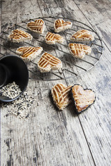Cookies whith sesame in the shape of heart on the metal grille