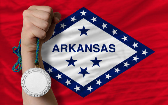 Silver medal for sport and flag of american state of arkansas