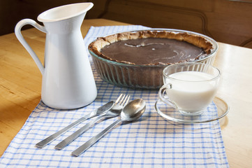 Cheesecake in a glass baking dish and milk jug