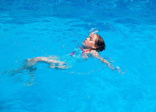 Child swimming backstroke