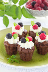 Fototapeta na wymiar Chocolate muffins with raspberries and cream.
