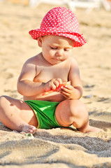 baby playing on the beach