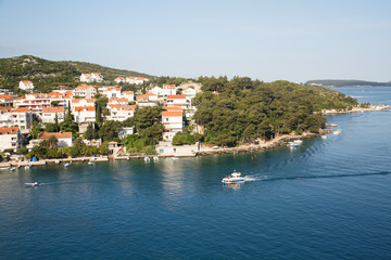 Fototapeta premium Pilot Boat Past Homes in Croatia