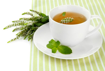 Cup of herbal tea with fresh mint flowers isolated on white