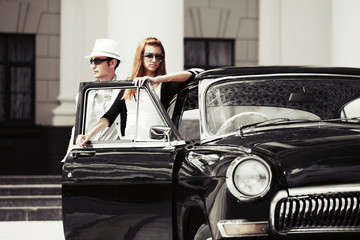 Young couple with a retro car