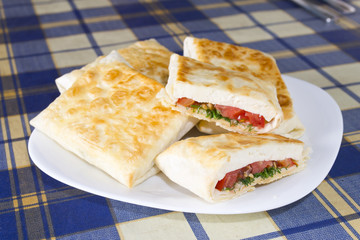 Pita bread with cheese, tomato and herbs
