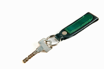 old key attached to a leather keychain