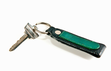 old key attached to a leather keychain